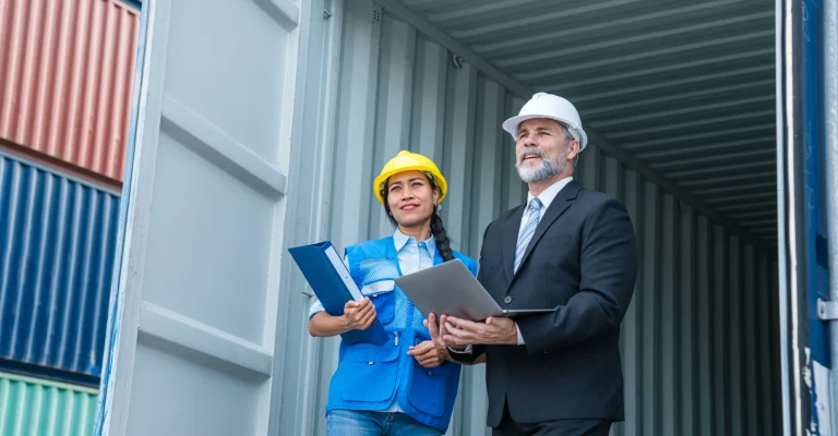 container-yard-manager-with-safety-hat-talking-to-2026-01-05-00-24-23-utc